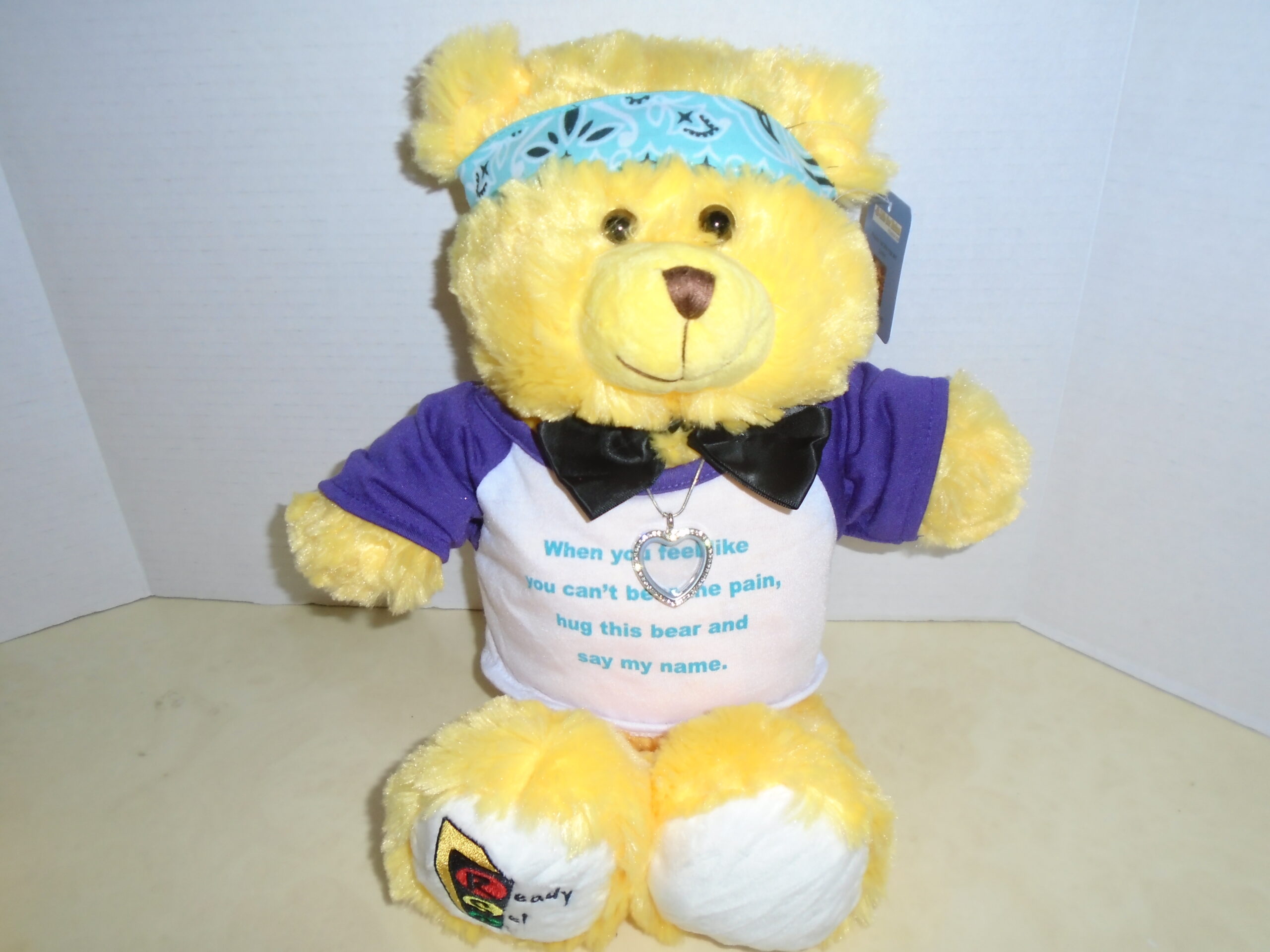 brian and briana yellow bear with a heart pendant